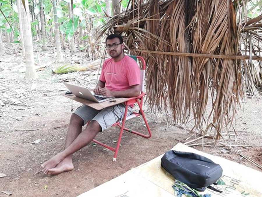 Vinayak Kallambi working under a hut.
