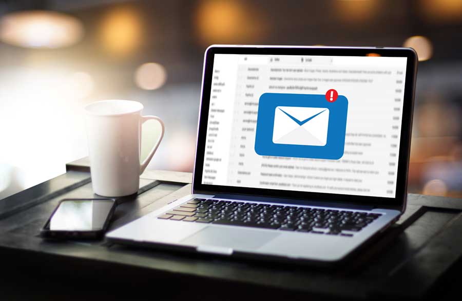 New email alert appears on computer screen.